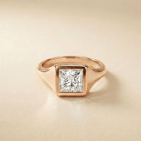 Rose gold ring with a diamond on a beige background Rose Gold