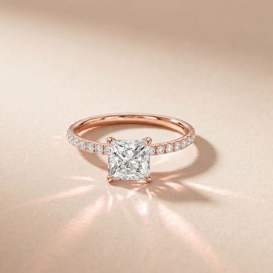 Rose gold ring with a diamond on a beige background