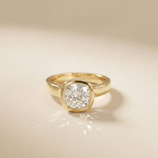 Gold ring with a diamond on a beige background