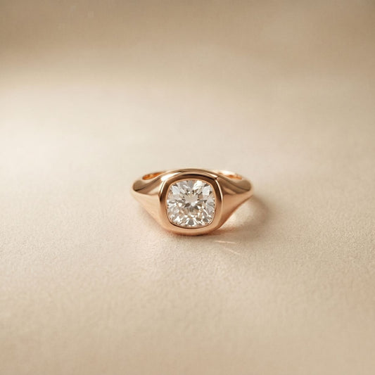 Rose gold ring with a diamond on a beige background