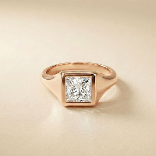 Rose gold ring with a diamond on a beige background