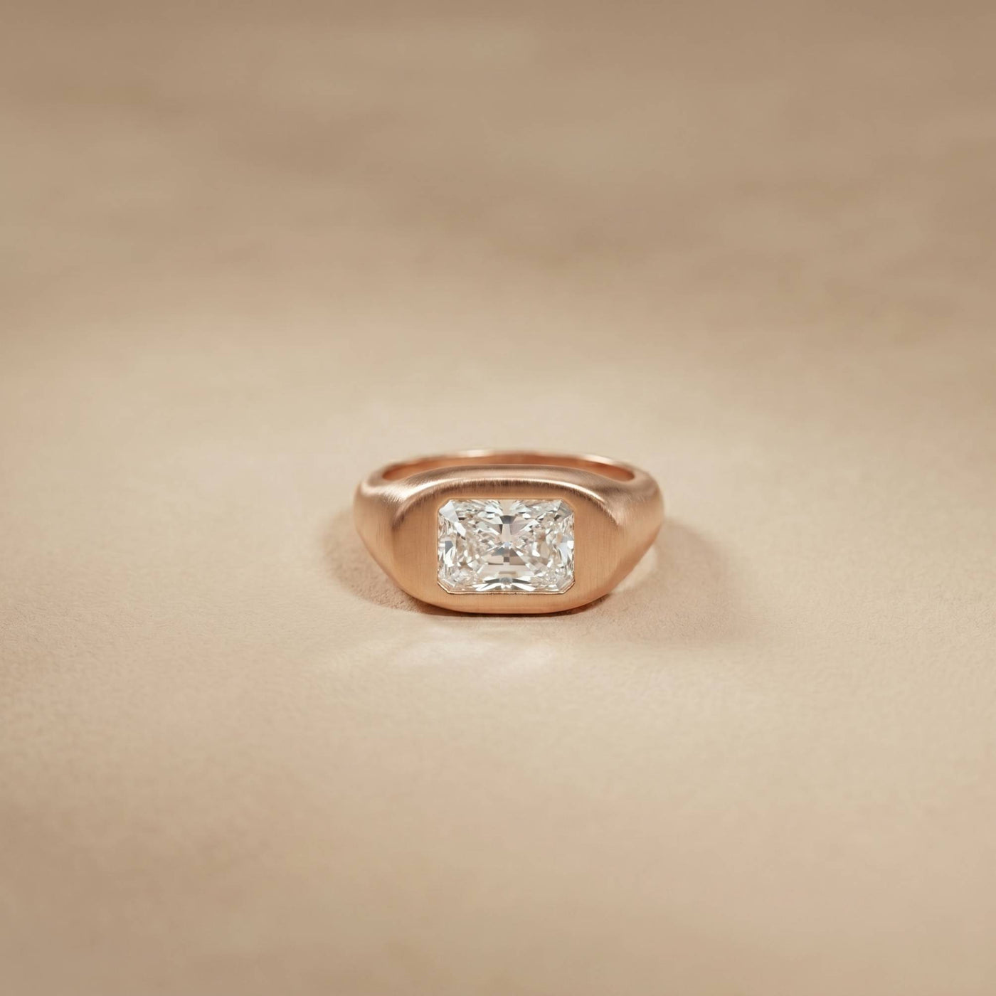 Rose gold ring with a diamond on a beige background Rose Gold