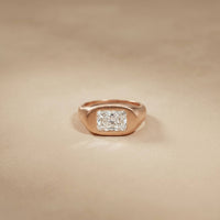 Rose gold ring with a diamond on a beige background Rose Gold