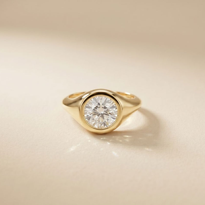 Gold ring with a diamond on a beige background Gold