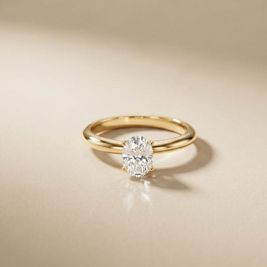 Gold ring with a diamond on a beige background