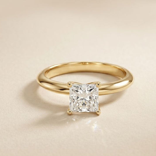 Gold ring with a diamond on a beige background