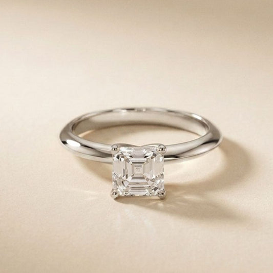 Silver ring with a diamond on a beige background