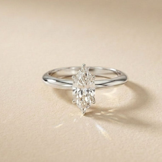 Silver ring with a diamond on a beige background