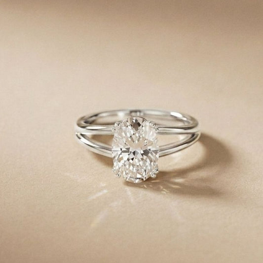 Silver ring with a diamond on a beige background