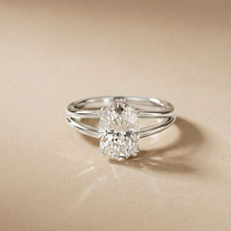 Silver ring with a diamond on a beige background White
