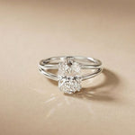 Silver ring with a diamond on a beige background White