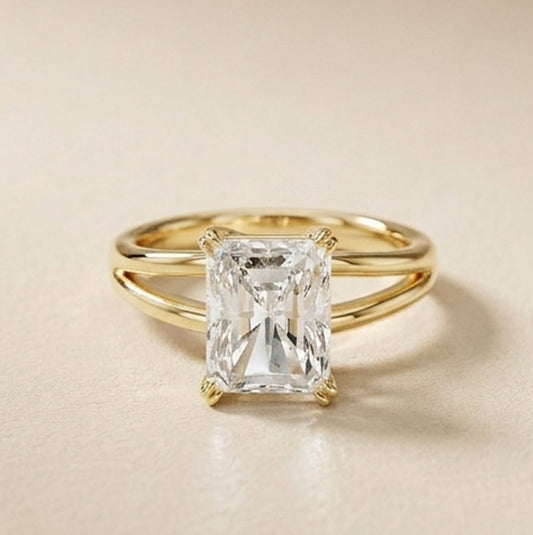 Gold ring with a rectangular diamond on a beige background