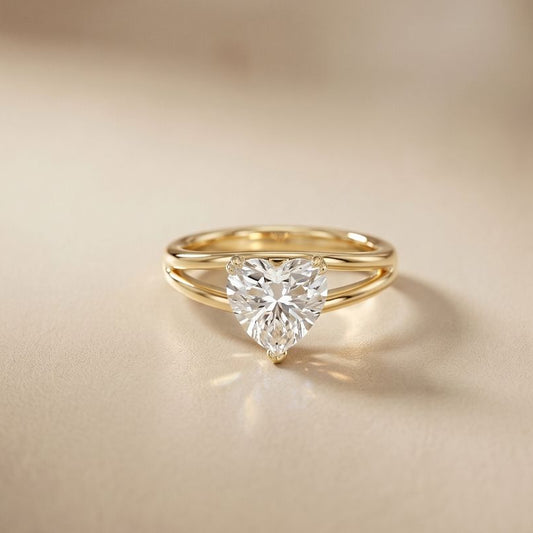 Gold ring with a heart-shaped diamond on a beige background