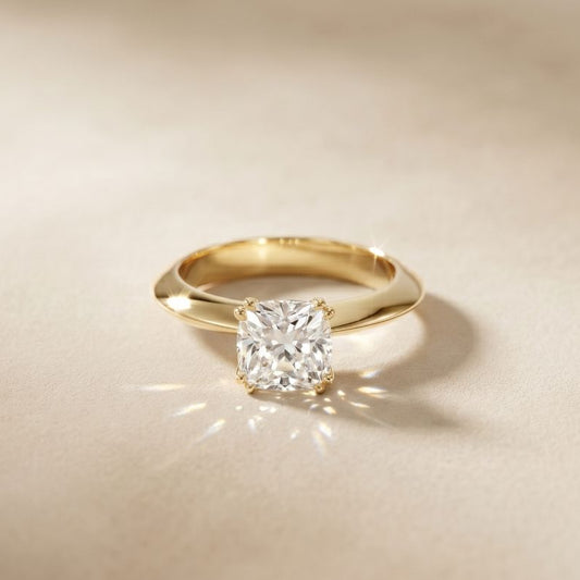 Gold ring with a diamond on a beige background