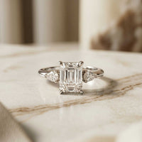 5.08 Ct Emerald Moissanite with Pear Side Stones Refined Accent Engagement Ring